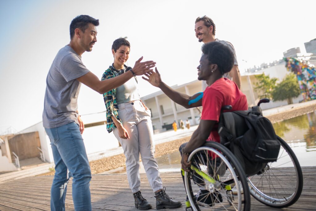 Friends greet each other outdoors , promoting diversity and inclusion.